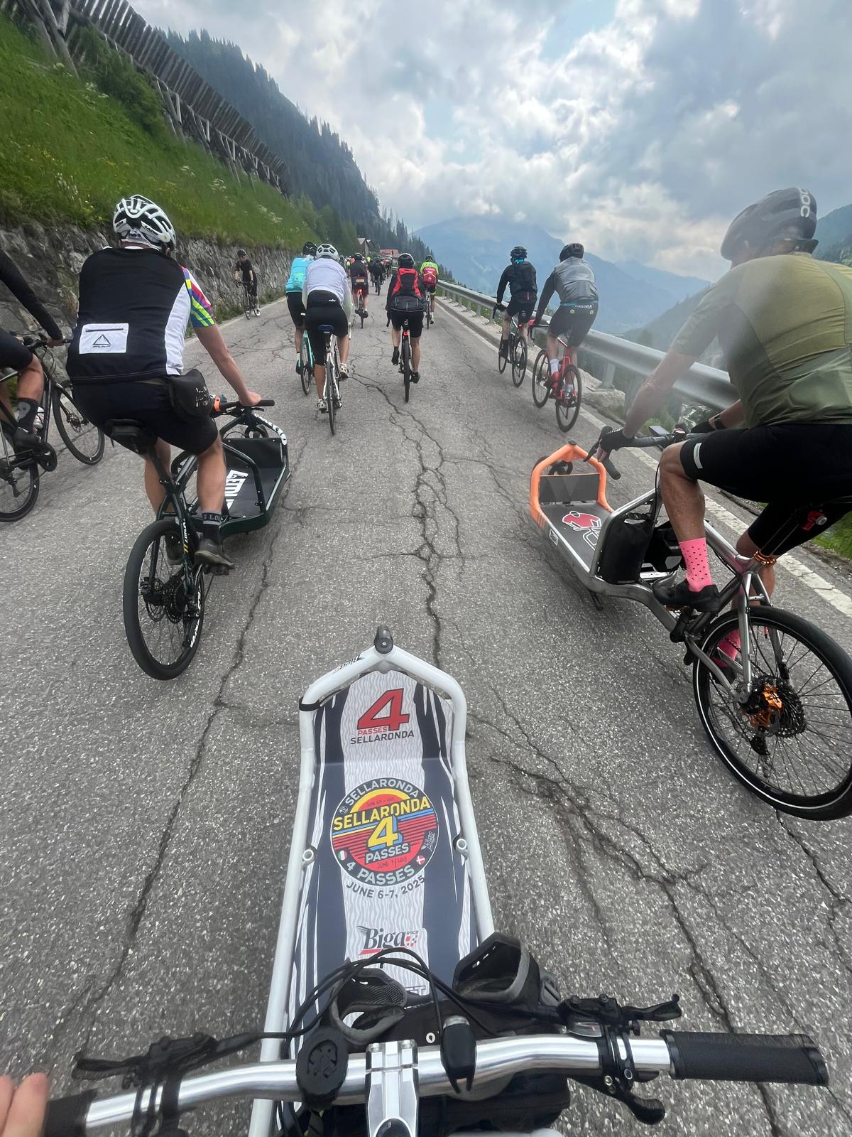 POV riding up Sellaronda pass with road cyclists